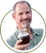 portrait picture of MonthlyClubs founder Kris Calef holding a glass of beer